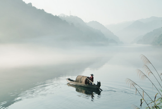 Fisherman from misty East Lake early in the morning, Dongjiang, Zixing, Chenzhou, Hunan, China