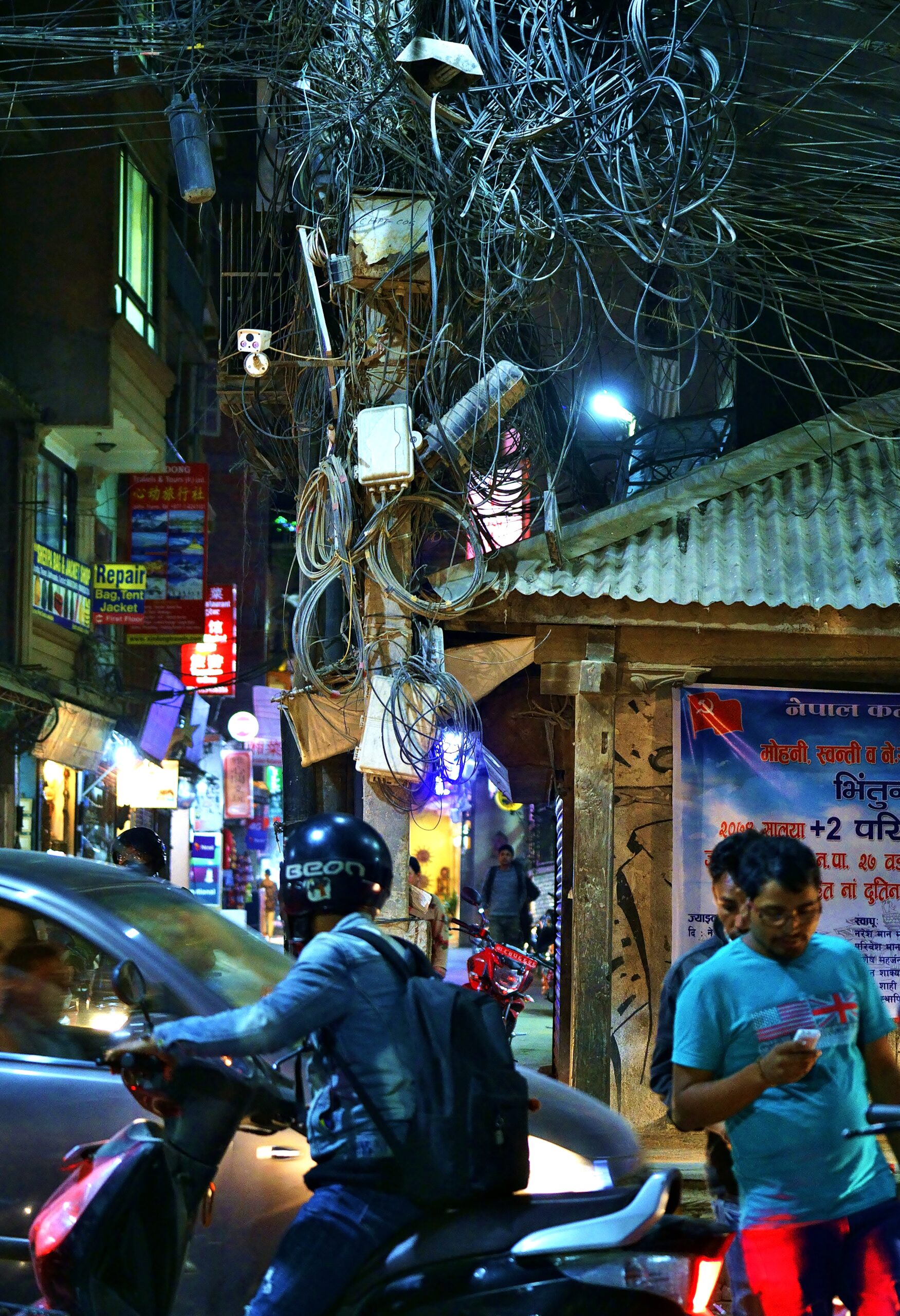 Traffic jam, black spagetti and focus on mobile in Thamel, down town Kathmandu, Nepal