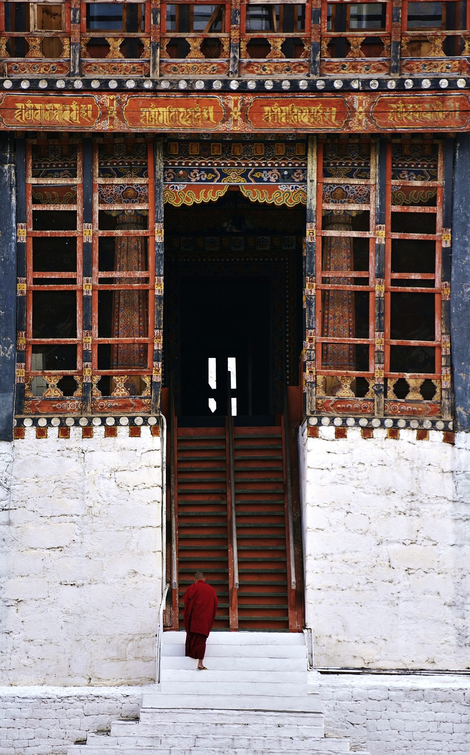 A young buddhist going up into Trashi Chhoe Dzong (Thimphu Monastery), Thimphu, Bhutan
