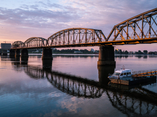 Broken Bridge over Yalu River at border in sunrise, Dandong, Liaoning, China//Xinuiju, North Korea (DPRK)